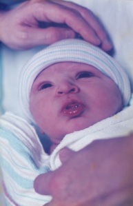 18 Years ago, Ethan came into the world. This is him with his father's hands.